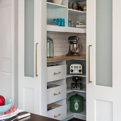 an open pantry with coffee maker and other kitchen items