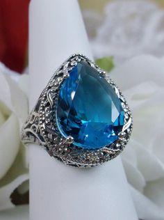 Swiss Blue Topaz Teardrop Ring, Simulated pear cut gemstone, Victorian filigree, sterling silver filigree, Antique jewelry, Silver Embrace jewelry, design #D28 Teardrop Topaz Ring For Anniversary, Formal Blue Pear-shaped Topaz Ring, Blue Pear-shaped Jewelry With Accent Stones, Anniversary Teardrop Topaz Ring, Formal Teardrop Blue Topaz Ring, Pear-shaped Blue Topaz Ring, Blue Teardrop Topaz Ring For Wedding, Teardrop Blue Ring With Accent Stones, Elegant Blue Teardrop Topaz Ring