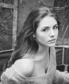 a black and white photo of a woman in a sweater