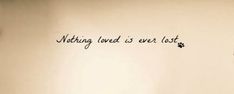 there is a wall with writing on it that says nothing loved is ever lost,