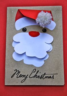 a christmas card with a santa clause on it's face and a pom - pom hat