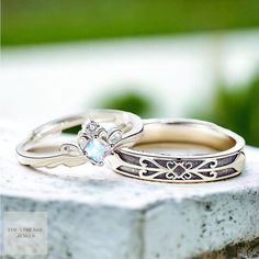 two wedding rings sitting on top of each other