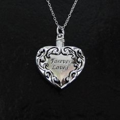 "A necklace that is not only beautiful, but functional! Heart Ash Container Necklace, Cremation jewelry, Pet Ashes. This pendant measures 25x28mm, (1\" wide). It unscrews at the top to hold your precious memories that will rest next to your own heart. I dropped it from a Sterling Silver chain that has a spring clasp and a 'Theresa Mink' signature tag attached. Choose your length in the option bar. Included is a black pouch, funnel, spoon, and toothpick. I also offer the love drop and the infinit Heart Container, Black Pouch, Clean Sterling Silver, Ashes Necklace, Silver Pendant Lighting, Filigree Heart, Pet Ashes, Golden Jewelry, Cremation Jewelry