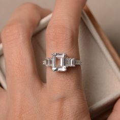 This ring features a 7*9mm white topaz and sterling silver finished with rhodium. Customization is available. It is made by hand, and it will take about 7 days to finish the ring after your payment is completed. Any question, just let me know. :) My shop homepage: https://www.etsy.com/shop/LuoJewelry?ref=l2-shopheader-name White Topaz Engagement Ring, Topaz Engagement Ring, Ring Promise, Topaz Ring, Ring Sterling Silver, White Topaz, Promise Ring, Sterling Ring, Emerald Cut