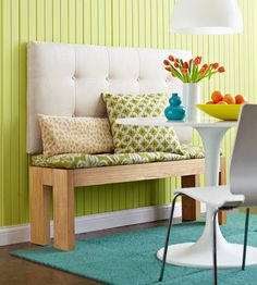 a white chair sitting next to a table on top of a green carpeted floor