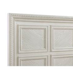 a white headboard with four paneled panels