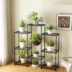 a set of four tiered plant stands with plants in them