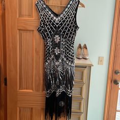 Perfect For A 1920s Party. Black And Silver Sequin Dress With Flapper Fringe. Beautiful And Never Worn. Nwt Black 1920s Flapper Dress For Costume Party, Black Art Deco Dress For Costume Party, Black Flapper Dress For Party, Art Deco Flapper Dress For Evening Parties, Black Sequined Art Deco Flapper Dress, Black Flapper Dress For Cocktail Events, Black Art Deco Flapper Dress With Sequins, Black Cocktail Flapper Dress, 1920s Black Flapper Dress For Cocktail