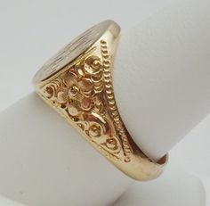 This is a really pretty signet ring from the Art Nouveau period. The ring has an oval signet area that measures 16 x 14 mm. The signet is already hand engraved with a monogram. The sides of the ring has a lovely carved floral design with a beaded edge. This ring is a nice size for either a man or a woman. The ring is stamped 14K and weighs 12.0 grams. The ring is engraved inside M B to P F. The ring is a size 10. *Sizing is available. Please message us for a quote* *We are always willing to ship Luxury Traditional Carved Rings, Luxury Antique Signet Ring With Single Cut Diamonds, Luxury Antique Engraved Filigree Ring, Luxury Vintage Signet Ring With Hallmarks, Luxury Antique Signet Ring Stamped 925, Luxury Vintage Signet Ring With Engraving Option, Luxury Victorian Engraved Yellow Gold Ring, Luxury Vintage Signet Ring With Polished Finish, Luxury Silver Art Deco Signet Ring