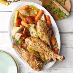 a white plate topped with chicken, carrots and celery