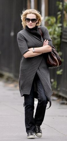 a woman walking down the street with her arms crossed