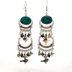 "Very Long Handmade Chrysocolla Wire Wrapped Dangle Earrings Set in Sterling Silver with Multiple gemstones and Shells ET968 Metal Content: 925 Sterling Silver and Stainless Steel Ear Wires Stones: 2 Oval Chrysocolla: 20mm x 15mm Stone Chips including; aventurine, tigers eye Shell Bird beads; abalone and mother of pearl Measurements Length:  4 7/16\" (113mm) Width:  1 1/8\" (28mm) Weight: 18.74 Grams Stamps: none Condition: Very Good Pre-Owned Each piece is thoroughly examined and refinished as needed by our professional jewelers, tested to guarantee metal content,  graded by our in-house GIA (Gemological Institute of America) Graduate Gemologist, and inspected for quality before being carefully packaged and promptly shipped. Thank you for taking the time to shop with us! We have hundreds Bohemian Jade Gemstone Earrings, Bohemian Jade Earrings, Nickel Free Bohemian Jade Earrings, Bohemian Nickel Free Jade Earrings, Bohemian Gemstone Dangle Chandelier Earrings, Bohemian Gemstone Chandelier Dangle Earrings, Bohemian Gemstone Chandelier Earrings, Bohemian Agate Earrings With Natural Stones, Bohemian Sterling Silver Gemstone Chandelier Earrings