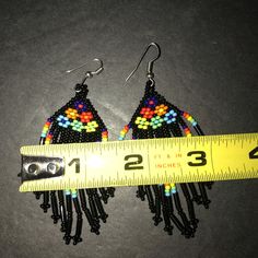 These Beautiful Earrings From Artisan Mxico Are A True Work Of Art. The Colorful Beads And Delicate Fringe Create A Boho Folk Style That Will Make Any Outfit Pop. Handmade In Mexico, These Earrings Showcase The Country's Rich Cultural Heritage. The Earrings Feature A Mix Of Black And Multicolored Beads, Adding A Playful Touch To Any Outfit. The Dangling Fringe Adds Movement And Texture, Making Them Perfect For A Night Out Or A Casual Day. Please See Photographs For A Better Understanding Of The Artisan Black Beaded Drop Earrings, Black Dangling Beads Jewelry For Beach, Beach Jewelry With Black Dangling Beads, Black Beach Jewelry With Dangling Beads, Artisan Black Beaded Earrings With Ear Wire, Artisan Black Earrings With Round Beads, Adjustable Multicolor Earrings With Large Beads, Yellow Beaded Earrings With Black Beads, Black Beaded Earrings For The Beach