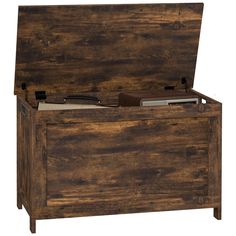 an old wooden chest with its lid open and some books in the bottom drawer on top