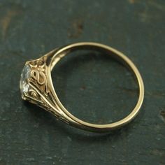 a close up view of a gold ring with a diamond in it's center