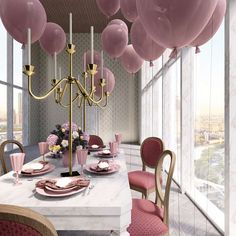 a dining room table with pink balloons hanging from the ceiling