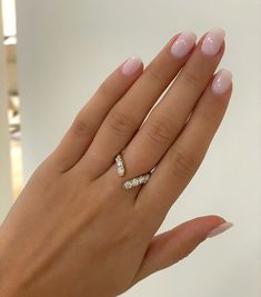 a woman's hand with two rings on it