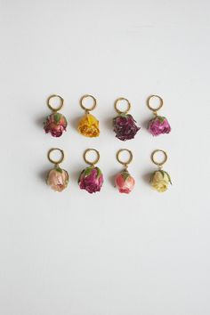 six rings with flowers on them are arranged in the shape of an ornament