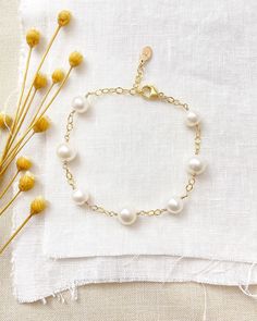 An ageless classic, this white freshwater pearl station bracelet is sure to become a go-to staple in any jewelry collection. Beautiful white cultured pearls on a textured, open-link chain give this piece an effortless, graceful style. Bracelet length:  7 inches plus 1 inch extender Materials:  gold fill, cultured freshwater pearls GIFTING ~ Jewelry gift box included. ~ I am happy to ship directly to the recipient.  Enter their address during checkout. ~ If you would like a gift note included in the package, please leave the text of the note in the "Add a note to Marsh Creek Jewelry" message box at checkout. FREE SHIPPING ~ Orders ship within 2 business days. ~ Free shipping is First Class ~ Priority Mail and Express Shipping upgrades are available during checkout. RETURNS ~ Returns accepte Classic Pearl Bracelet With Extender, Elegant White Pearl Bracelet With Extender, Everyday White Pearl Bracelet With Extender, Classic Pearl Bracelet With Extender For Gift, Timeless White Pearl Bracelet With Charm, Minimalist White Pearl Bracelet For Anniversary, Timeless White Pearl Bracelet For Anniversary, Classic Pearl White Hypoallergenic Pearl Bracelet, Classic White Jewelry With Extender