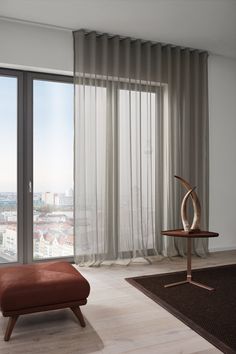 a living room with a large window overlooking the city