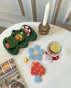 there is a candle and some crocheted items on the table