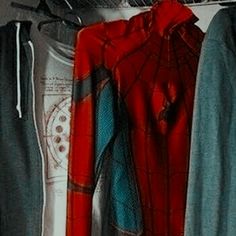 spider - man's clothes are hanging on a rack