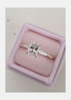 an engagement ring in a pink velvet box