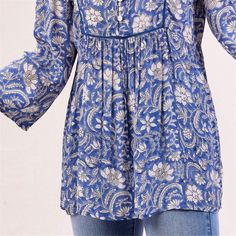 Embrace bohemian charm and effortless style with the Jasmine Blue Bohemian Tunic. Crafted from 100% viscose, this tunic offers both comfort and breathability, perfect for all-day wear. The vibrant blue pattern adds a lively touch to your look, making it a standout piece in your wardrobe. The 3/4 sleeves provide a relaxed yet polished look, while the inner lace detail on the placket adds a touch of femininity and elegance. Featuring a half placket adorned with shell buttons, this tunic exudes und Flowy Viscose Tunic, Blue V-neck Tunic For Spring, Bohemian Rayon Top With Boho Print, Bohemian Boho Print Rayon Tops, Festival Boho Print Rayon Blouse, Bohemian V-neck Rayon Peasant Top, Bohemian Patterned V-neck Peasant Top, Casual Flowy Rayon Tunic, Blue Bohemian Peasant Top In Relaxed Fit