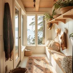 a room filled with lots of wooden shelves and furniture next to a window covered in plants