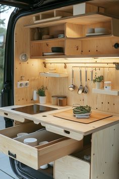 the interior of a van with drawers and utensils