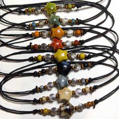 Looking for a unique and eye-catching accessory to add to your collection? Look no further than this Ceramic Beaded Star Spiral Swirl Y2K Boho Hippie Whimsical Adjustable Black Rope Cord Choker Stacking Necklace. Crafted from high-quality ceramic beads this whimsical necklace is the perfect addition to your boho-inspired wardrobe. With nine different color options available, each necklace is made-to-order and features a slightly unique color variation. Designed on an adjustable waxed black cord Multicolor Star-shaped Adjustable Necklace, Festival Handmade Star Beaded Necklaces, Handmade Star Beaded Necklaces For Festivals, Adjustable Star-shaped Necklace With Colorful Beads, Handmade Star-shaped Beaded Necklace For Festivals, Handmade Adjustable Star Necklace, Adjustable Star Charm Festival Jewelry, Adjustable Star Charm Jewelry For Festivals, Adjustable Star-shaped Bohemian Jewelry