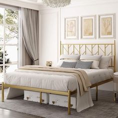 a bedroom with white walls and gold bed frame