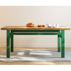 a wooden table with two bowls of fruit on it and a bowl of oranges