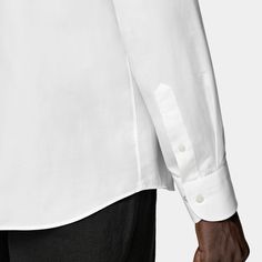 On its own or paired with a jacket, this casually refined white shirt is tailored slim with large point collar, and neat french placket, and a subtly curved hemline that's perfect for wearing untucked. White Long Sleeve Dress Shirt With Concealed Placket, Elegant Shirt With Placket And Shirttail Hem, Elegant Shirt With Shirttail Hem And Placket, Modern Shirttail Hem Shirt For Business Casual, White Tops With Lapel Collar And Concealed Placket, Modern White Long Sleeve Dress Shirt, Spring Timeless Collared Dress Shirt, Timeless White Shirt With Placket, White Shirt With Hidden Button Closure For Spring