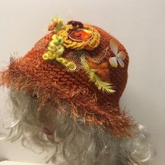 This burnt orange hat is so good for boring and colorful winter days.  It reminds you about hot summer, flowers and butterflies. All these beautiful things you see on the hat. To add more charm to this crocheted hat I trimmed the brim with a fur looking yarn. One of a kind hat. Hand crocheted with a wool blend yarn this hat is warm. Fits most of average and big adults heads. Comes from my smoke and pet free studio. To see more of my unique handmade hats, click here: https://www.etsy.com/shop/Iryna?section_id=22590274 Best wishes from Iryna Beach Bucket Hat For Fall, Orange Wide Brim Hat For Spring, Orange Wide Brim Sun Hat, Fall Beach Bucket Hat, Trendy Festival Mini Hats, Whimsical Wide Brim Winter Hat, One Size Fall Hat With Short Brim, Orange Curved Brim Hat For Spring, Brown Bucket Hat For Fall