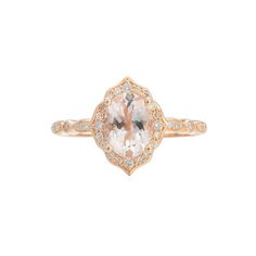 an oval shaped ring with diamonds on the sides and a center stone in the middle