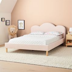 a bedroom with a bed, nightstands and a teddy bear on the floor next to it