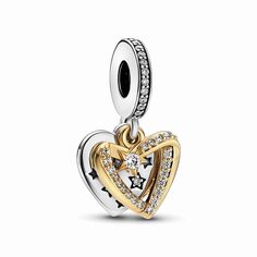 Add a celestial dimension to Chinese Valentine's Day with our Shooting Star Hearts Double Dangle Charm. This two-tone symbol of heavenly romance features a 14k gold-plated heart, decorated with a constellation of sparkling stars. The second dangle is a sterling silver heart engraved with the message: "You are my galaxy." Inspired by the tale of the Sky Emperor's daughter Zhin� and her earthly lover, it's the perfect way to celebrate your union; a shining reminder that true love knows no limits. Heart Galaxy, Charms Pandora, Bracelet Pandora, Pandora Charm, Shooting Star, Shooting Stars, Dangle Charms, Pandora Bracelet, Geometric Earrings