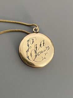 "Weight: 11.9g Dimensions: 1\" round, 18\" chain Hallmarks: Makers mark L & M Although these lockets were patented in the year 1902, this particular locket states on its backside that it is from the 'class of '12' dating it to a decade later. This is a very unique locket in that it has 3 windows and folds like an accordion. All bezels are present and the two clear windows inside the front and back covers are still present. The locket measures 1\" round and comes on an 18\" GF chain. Very lig Vintage 14k Gold Locket Necklace, Vintage 14k Gold Locket Necklace Stamped 14k, Vintage Oval Necklace With Coin Pendant, Vintage Oval Jewelry With Coin Pendant, Victorian Round Locket Necklace Stamped 14k, Antique Medallion Locket Necklace Stamped 14k, Victorian Vintage Charm Round Locket Necklace, Victorian Style Vintage Charm Round Locket Necklace, Classic Vintage Charm Locket Necklace