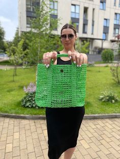 Introducing our stylish knitted summer bag, a perfect blend of elegance and practicality for young women and girls. This charming green bag is meticulously handcrafted using high-quality yarn, ensuring a durable and fashionable accessory that will complement any summer outfit. Designed with a short handle, this bag is ideal for casual outings, beach trips, or any occasion where you want to carry your essentials in style. The intricate crochet patterns create a beautiful texture, adding depth and Trendy Green Handmade Straw Bag, Trendy Green Straw Shopping Bag, Trendy Green Crochet Bag With Braided Handles, Green Crochet Bag With Braided Handles, Handwoven Green Crochet Beach Bag, Green Crochet Tote Straw Bag, Trendy Green Crochet Shopping Bag, Handmade Green Shoulder Bag For Beach, Green Crochet Straw Tote Bag