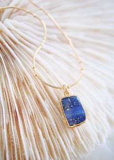 18kt Gold Filled Necklace featuring a starry Lapis Lazuli slice gemstone plated in gold. Dignified Lapis Lazuli encourages self-awareness, allows self-expression and reveals inner truth, providing qualities of honesty, compassion and morality to the personality. It also promotes stronger self 14k Gold Filled Gemstone Pendant Necklace, Celestial Gold Jewelry With Rectangular Pendant, Gold Celestial Jewelry With Rectangular Pendant, Gold Necklace With Rectangular Pendant In Fine Jewelry Style, Fine Jewelry Gold Necklace With Rectangular Pendant, Celestial Gold Gemstone Jewelry, Celestial Gemstone Necklace In Yellow Gold, Celestial Yellow Gold Gemstone Necklaces, Celestial Pendant Necklace With Natural Stones