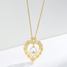 Vintage Hollow Heart Freshwater Pearl Pendant Necklace This elegant Vintage Hollow Heart Freshwater Pearl Pendant Necklace features a 7-8mm pearl set in a gold vermeil pendant. The timeless design and high-quality materials make it a perfect addition to any jewelry collection. Add a touch of vintage charm to your style while enjoying the natural beauty and elegance of freshwater pearls. Necklace Chain, material 925 sterling silver Length: 40cm with an extension of 5cm Product Information Pearl T Exquisite Gold Jewelry With Pearl Pendant, Gold Necklace With Pearl Chain For Valentine's Day, Valentine's Day Gold Necklace With Pearl Chain, Valentine's Day Gold Pearl Chain Necklace, Gold Pendant Pearl Necklace With Heart Charm, Elegant Heart Necklace For Wedding, Gold Pearl Necklace With Heart Charm And Pendant, Gold Heart Necklace With Pearl Charm As Gift, Gold Plated Pearl Pendant Jewelry For Anniversary