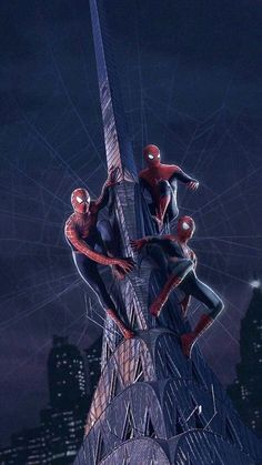 two spider - man are climbing up the side of a tall building in front of a city at night