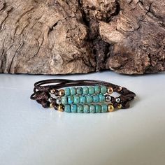 Beautiful Opaque Turquoise Sea Foam Colored beaded unisex cord bracelet for men and women of all ages.  This adjustable waterproof bracelet is made with strong lightweight 1mm waxed polyester/nylon cord that is fast drying, color fast, and non fraying.  There are seven stunning high quality 4mm Miyuki Picasso glass beads.  We've also added 4mm stainless steel beads to flank the sides of the glass beads, and two little coordinating 3mm beads that will move freely on your cord.  For the stainless beads you get to choose from three colors.  Our video and listing photos showcase all of our Miyuki Picasso bead color bracelets.  Follow the link below to order your bracelet in one of the other bead colors. VIEW ALL OUR CORD BRACELETS HERE: https://www.etsy.com/shop/OtterlyCharmingUSA?ref=seller-p Turquoise Beaded Bracelets With 8mm Beads For Beach, Adjustable Turquoise Wrap Bracelet For Festival, Adjustable Turquoise Resizable Bracelet, Adjustable Turquoise Hand-strung Wrap Bracelet, Adjustable Turquoise Hand-strung Beaded Bracelets, Adjustable Hand-strung Turquoise Beaded Bracelets, Adjustable Turquoise Wrap Bracelet, Adjustable Turquoise Bracelets With Sliding Knot, Adjustable Turquoise Bracelet With Sliding Knot