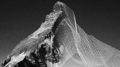 a mountain covered in snow with a net covering it