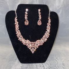 This Necklace Set Features A Silver Tone With Pink Sparkling Jewels. Comes With Necklace And Matching Earrings. Cheap Elegant Pink Rhinestone Necklace, Elegant Pink Rhinestone Necklaces, Glamorous Pink Rhinestone Necklace, Pink Multi-stone Necklaces For Gifts, Silver Crystal Necklace, Elegant Pink Multi-stone Necklace, Ear Ring, Neck Lace, Silver Crystal