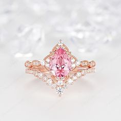 an engagement ring with a pink diamond in the center and white diamonds around it on top