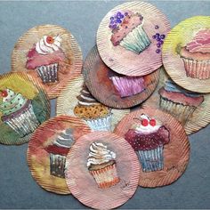 some cupcakes are painted on paper plates