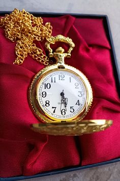 This gold-colored pocket watch with quartz mechanism combines an old style with old engravings to make it an original gift. The watch features an easy-to-read dial with metal numbers and hands. This is a unique and thoughtful gift. Vintage pocket watch made in the 2000s. Collectible pocket watch, rare model (reproduction of a solid gold pocket watch from the 18-19th century) The watch is in a rare state of conservation. -Delivered in a gift box (see photo). -Movement type: quartz (new battery in Gold Pocket Watch For Anniversary Timeless Style, Timeless Gold Watch For Gift, Timeless Gold Watch As Gift, Timeless Gold Watch As A Gift, Timeless Gold Pocket Watch With Round Dial, Antique Gold Timeless Pocket Watch As Gift, Gold Watches With Round Dial For Gift, Gold Watches Suitable As Gifts, Gold Watches For Gifts