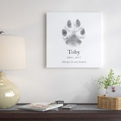 a dog's paw is shown on the wall above a table with a lamp